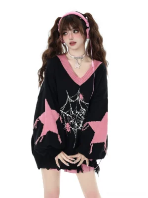 Black V-neck core-spun yarn knit sweater with pink star and spider web print worn by model with twin tails and pink headphones showing frayed hem detail