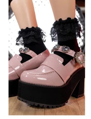 Black Jirai Kei lace ruffle ankle socks with cross and wing patterns multi-layered ruffles worn with pink loafers front angle view