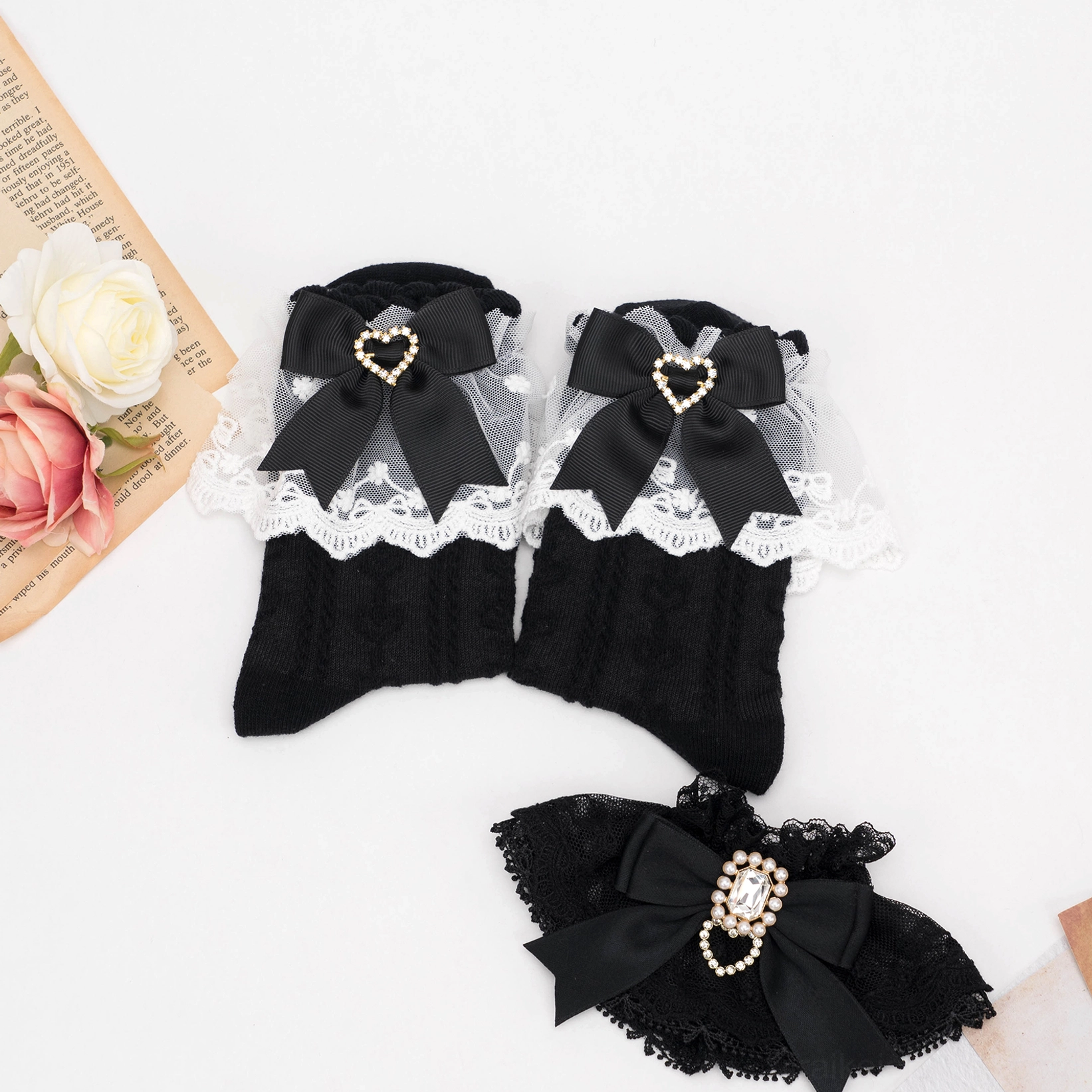 Black cable-knit Jirai Kei lace socks with sheer lace cuff and heart rhinestone bow embellishment detail flat lay styling