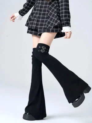 black y2k jirai kei flared leg warmers with double heart buckle accents over-the-knee style worn with black plaid two-piece set and platform loafers side view