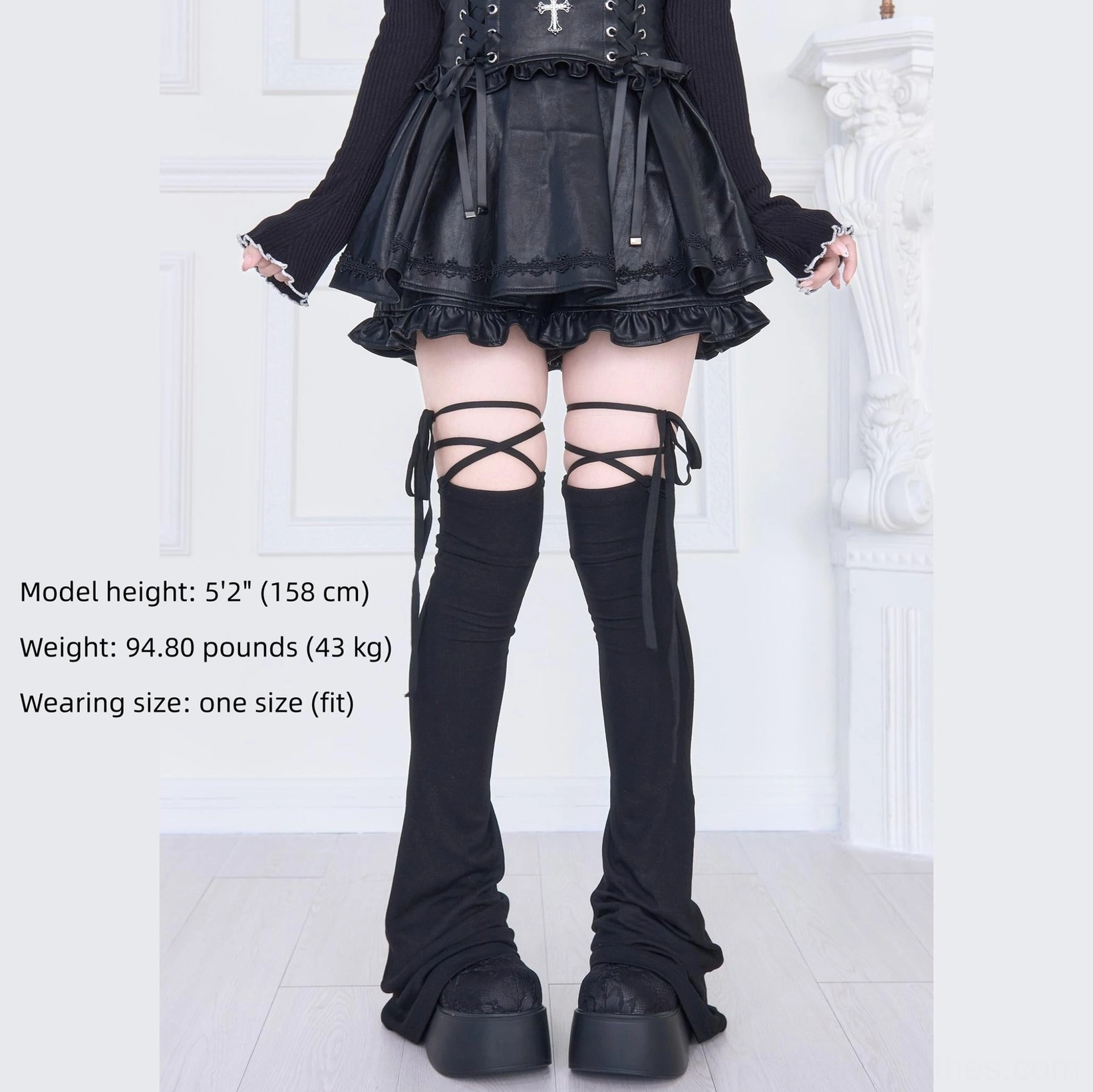 Black lace-up thigh-high leg warmers front view with crisscross strap details and product specifications height weight sizing chart