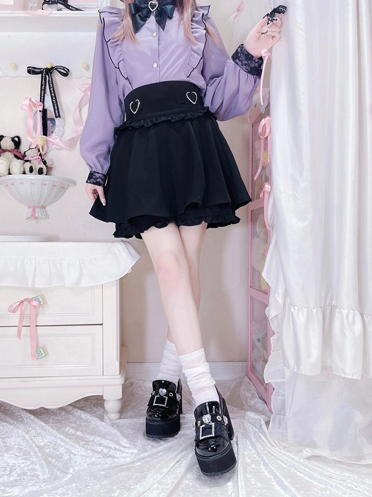 Full body low side view of model wearing black Jirai Kei platform loafers with square rhinestone buckles paired with purple blouse and black skirt in doll-themed room