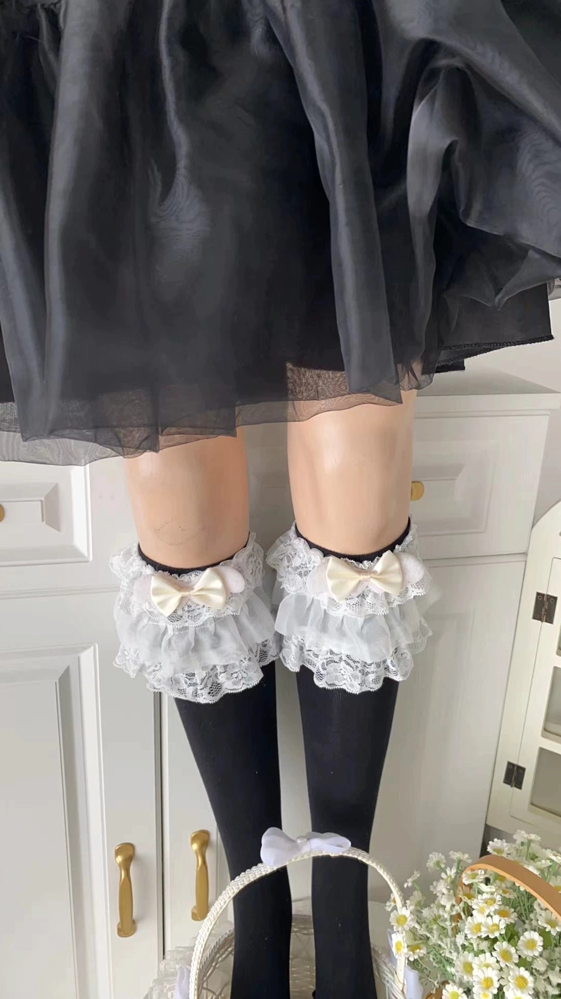 Black jirai kei lolita calf socks with multi-layered ruffled lace cuff and bow embellishments detailed product shot