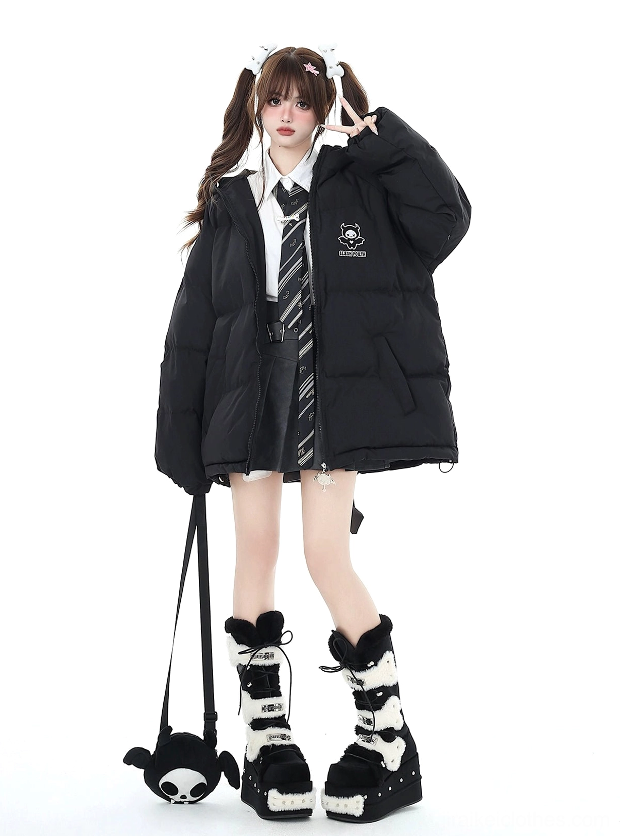 Black oversized Jirai Kei winter puffer jacket front view with chest cartoon logo and detachable devil bag on twin-tail school uniform model