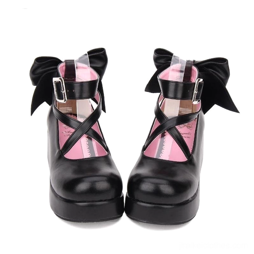 Black Jirai Kei platform Mary Janes with oversized back bow and cross ankle strap with metal buckle, front flat view, pink padded insole visible