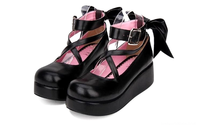 Black Jirai Kei platform Mary Janes front view with visible thick platform sole, crisscross ankle strap with metal buckle, pink padded insole