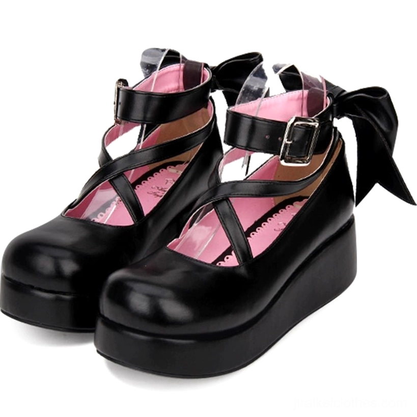 Black Jirai Kei platform Mary Janes side three-quarter view showing thick platform sole, oversized back bow, crisscross ankle strap with buckle