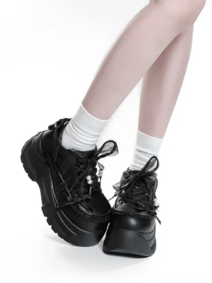 Black Jirai Kei platform shoes side view worn with white crew socks showing lace and pearl shoelace decorations and chunky thick sole detail