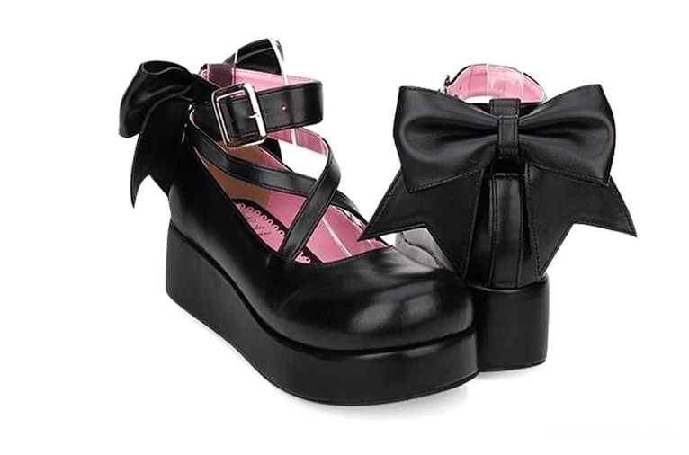 Rear side view of black Jirai Kei platform shoes displaying prominent back bow design, adjustable crisscross ankle strap, chunky platform sole