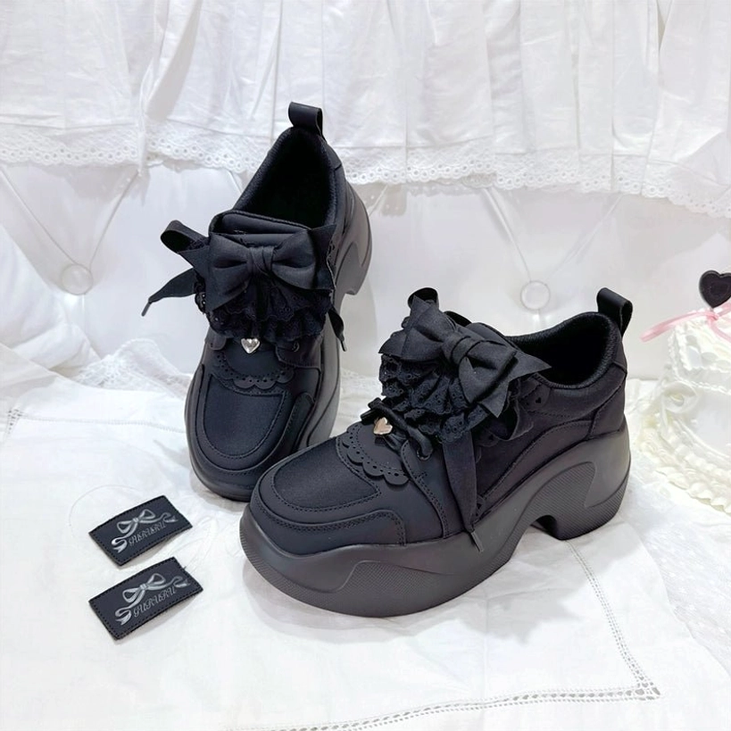 Black Jirai Kei platform sneakers product photography matte black cowhide upper lace bow ruffle trim chunky seven centimeter heel studio