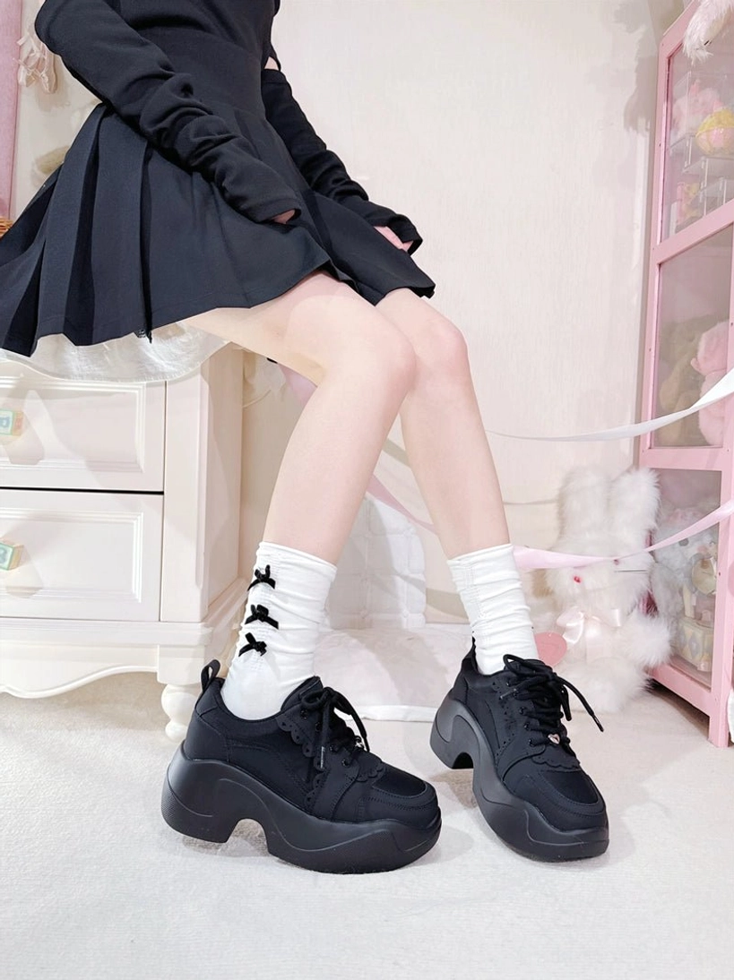 Black Jirai Kei platform sneakers low side single foot view model gray cropped jacket white socks large tongue bow chunky platform studio