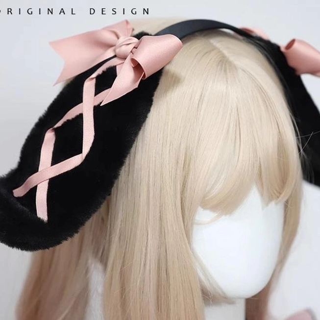 Black rabbit ear hairband close-up three-quarter view on mannequin wig display with fluffy black ears pink crisscross ribbon and pink satin bows