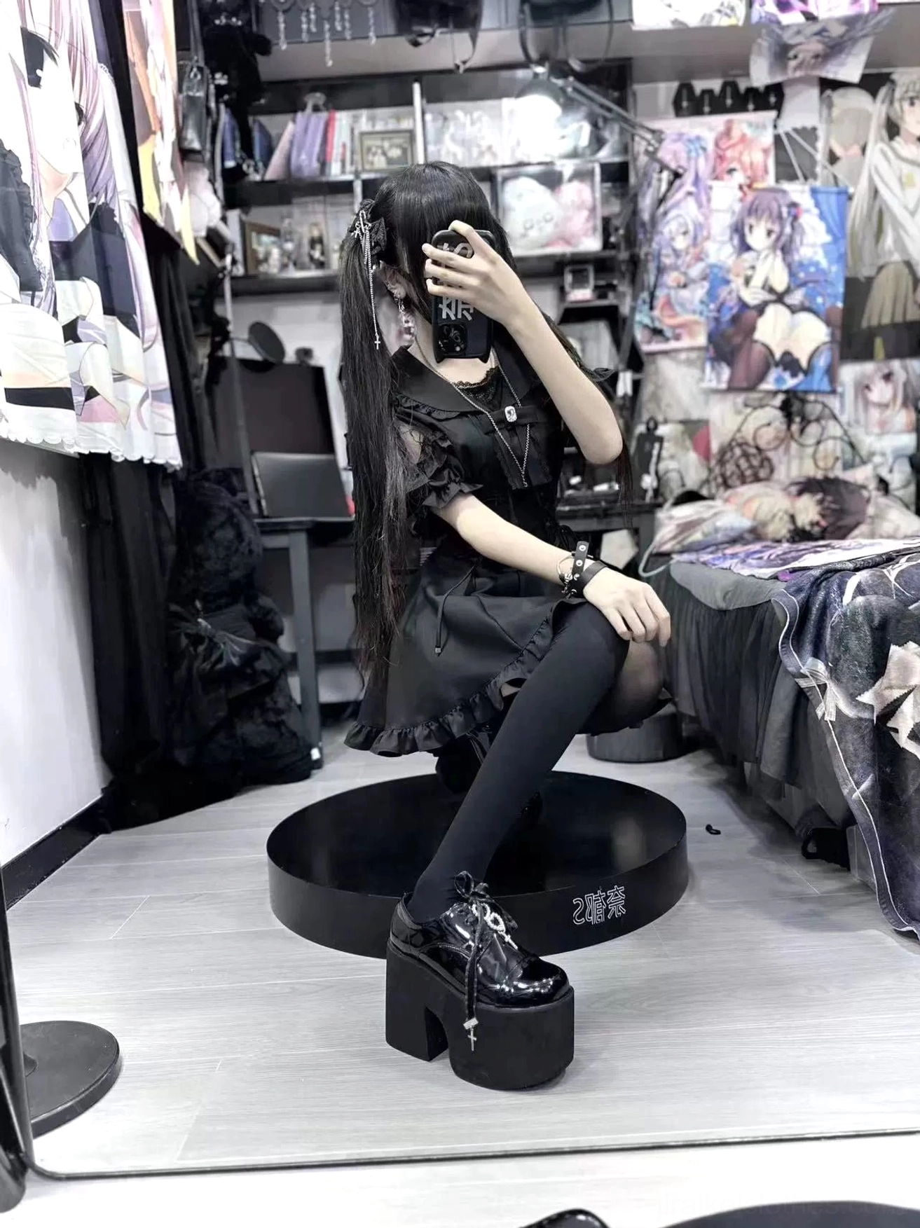 Black Jirai Kei sailor dress side mirror view with platform boots wrist accessory and hand pose