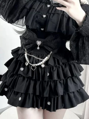 Black Jirai Kei high-waisted skirt with multi-layered ruffles and detachable pearl chain close-up detail shot