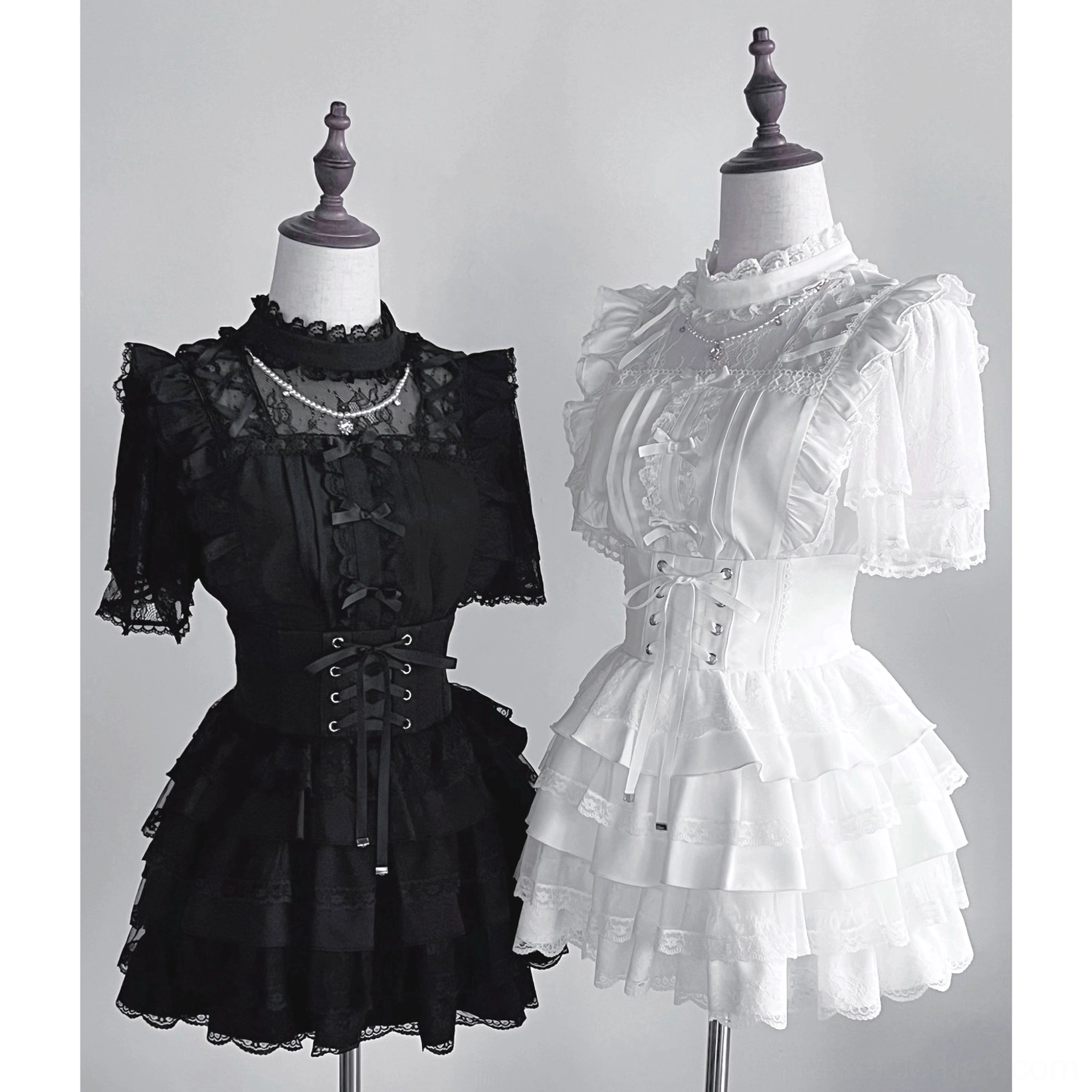 Black jirai kei tiered cake skirt standalone full-length view showing layered ruffle silhouette corset waistband and gothic lolita aesthetic