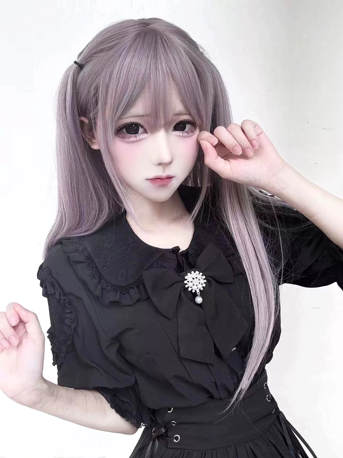 Black Jirai Kei blouse and skirt two-piece set on purple twin-tailed anime model, displaying lace peter pan collar, puffed short sleeves, corset waist details, and high-waisted skirt silhouette - gothic fashion ensemble