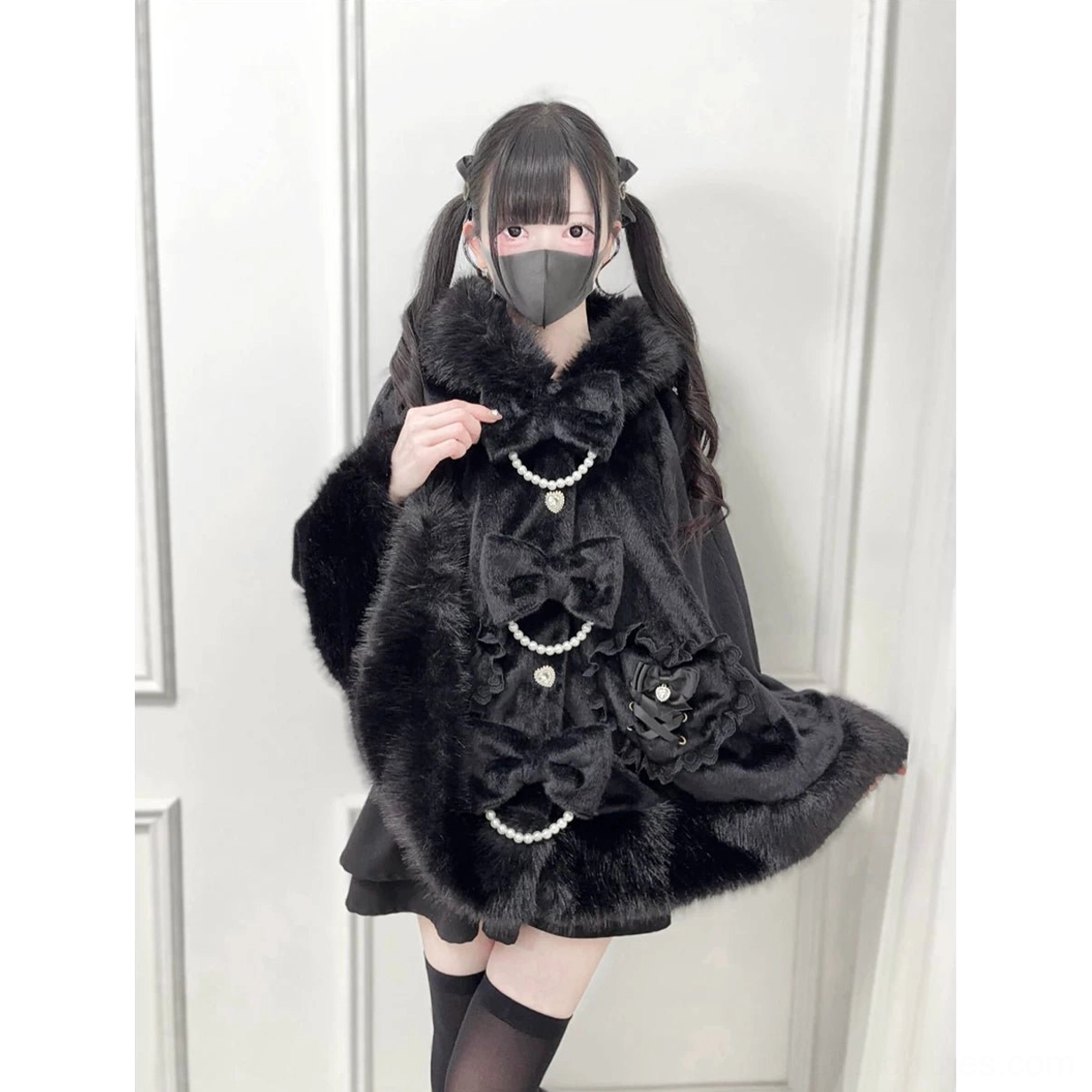 Black faux fur Jirai Kei winter cape close-up detail view showing plush fabric and pearl bow chain decorations