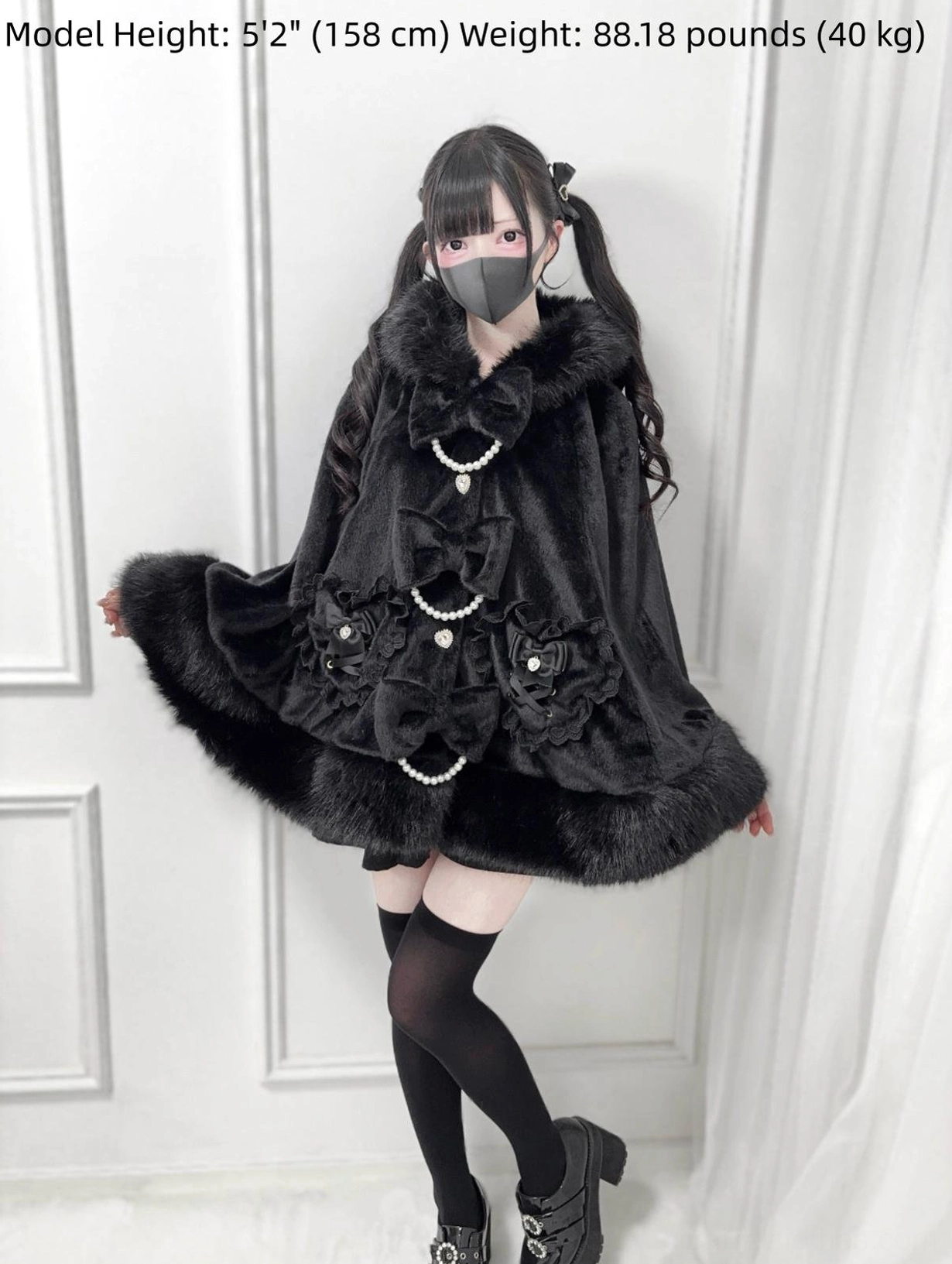 Black Jirai Kei winter cape front full view with faux fur hood and trim, pearl chain and bow embellishments