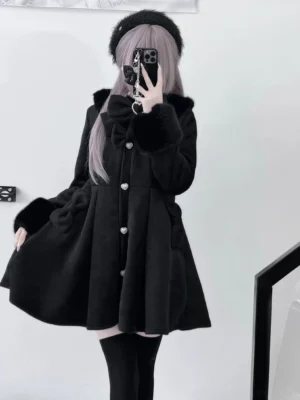 Black wool fleece Jirai Kei winter coat with plush Peter Pan collar and bow detail worn by model in mirror selfie front three-quarter view