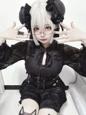 Black Chinese-style lace cheongsam dress set with long sleeves frog collar and corset waist design modeled indoors on sofa background showing ruffled hem details