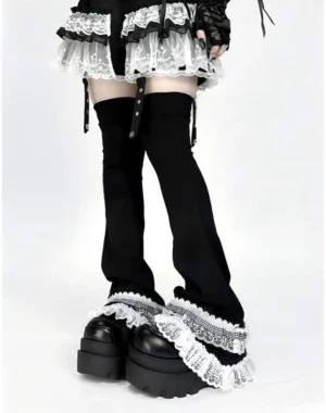 Lace-trimmed goth leg warmers featuring double-layer white ruffles and black flared design with buckle fasteners, low-angle leg showcase