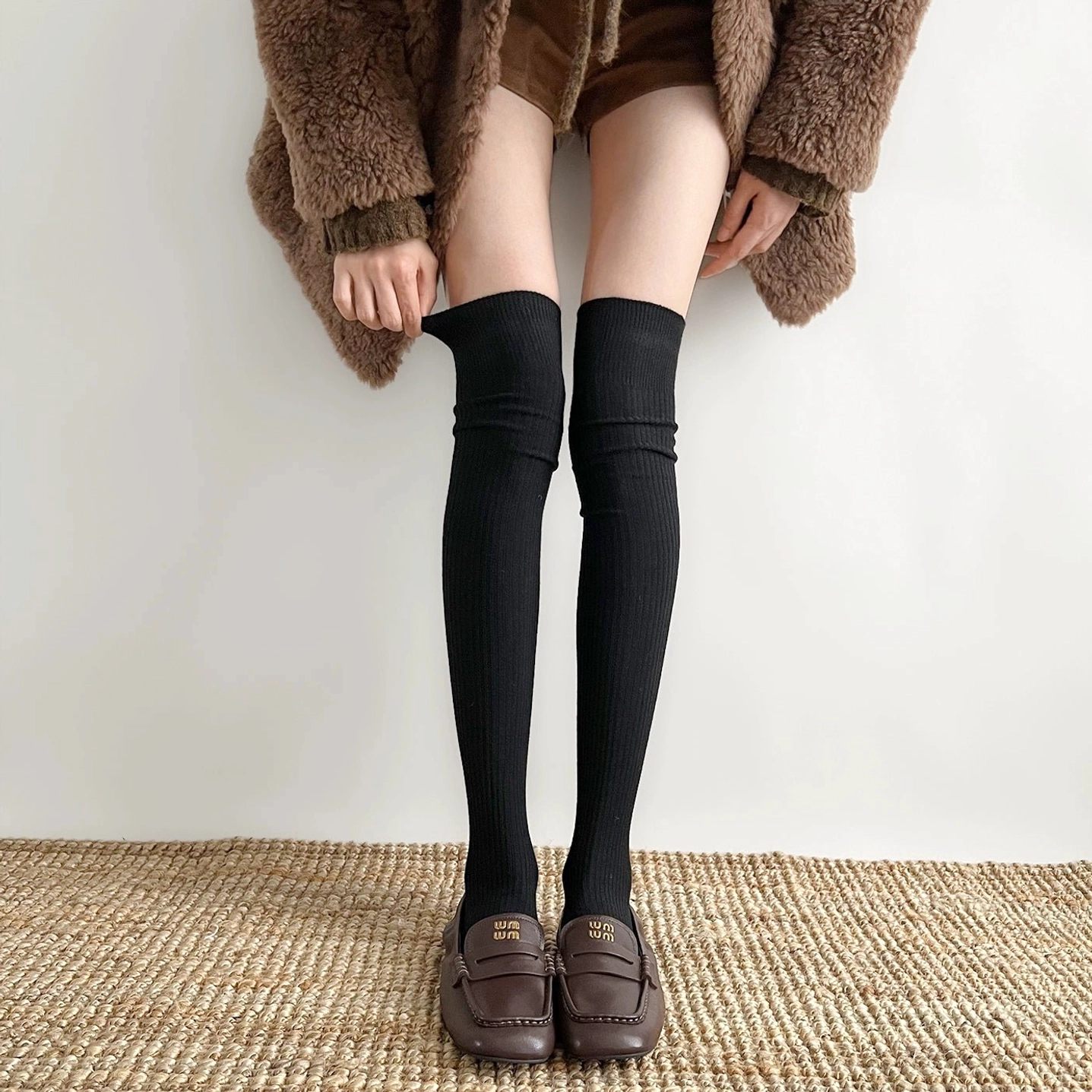 Black over-the-knee ribbed socks Jirai Kei aesthetic worn with loafers fuzzy coat studio styling