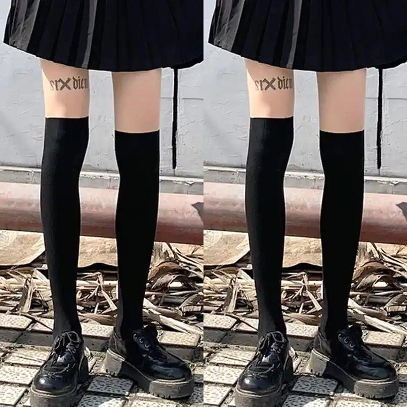 Black over-the-knee socks model holding chain handbag gray coat platform shoes solid black tight fabric