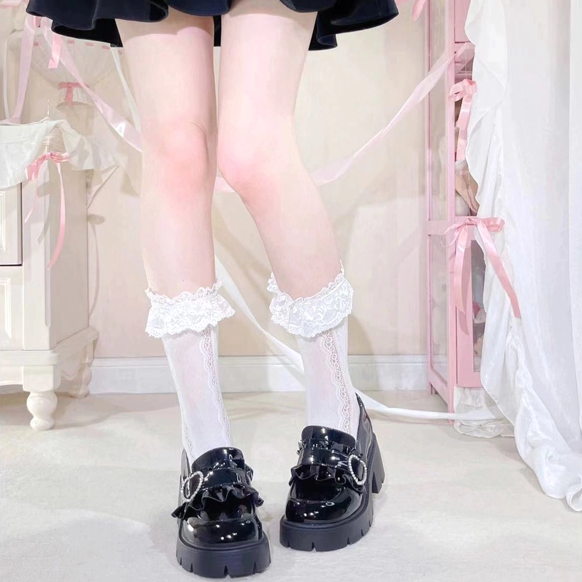 Black patent platform loafers Jirai Kei style paired with lace-trimmed white socks black mini skirt full lower leg shot pink girly bedroom setting