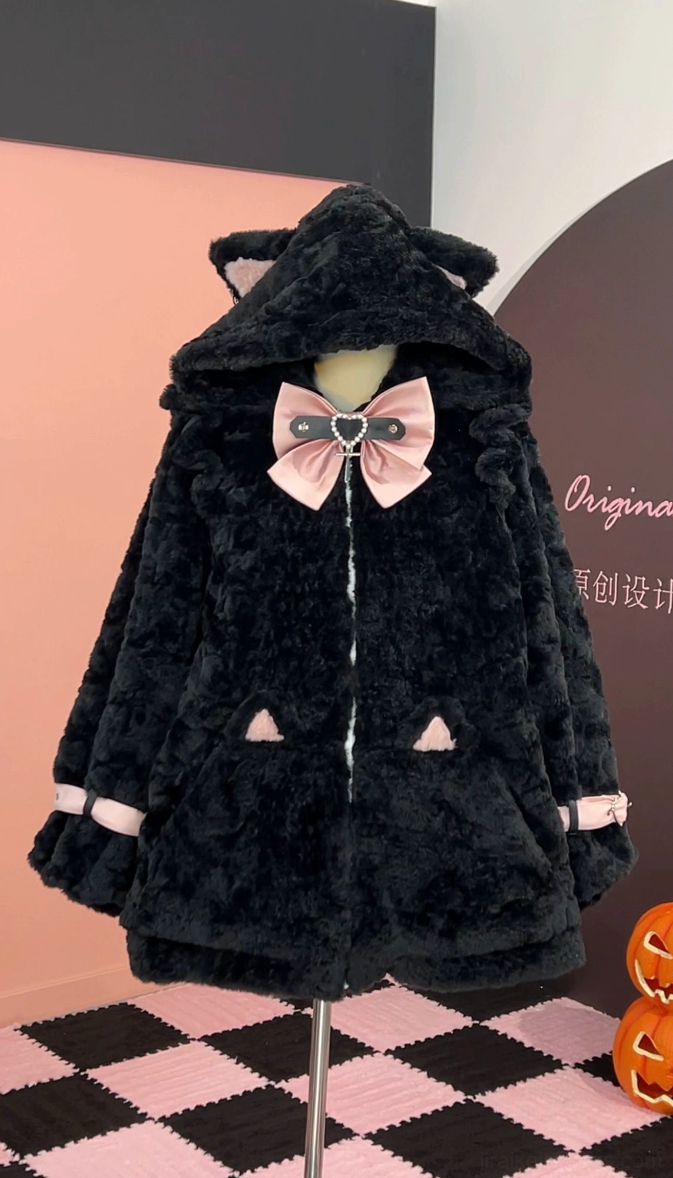 Black and pink Jirai Kei fleece coat with cat ear hood, pink bow decoration, pink hood ear accents, cat ear pocket patches, front mannequin view