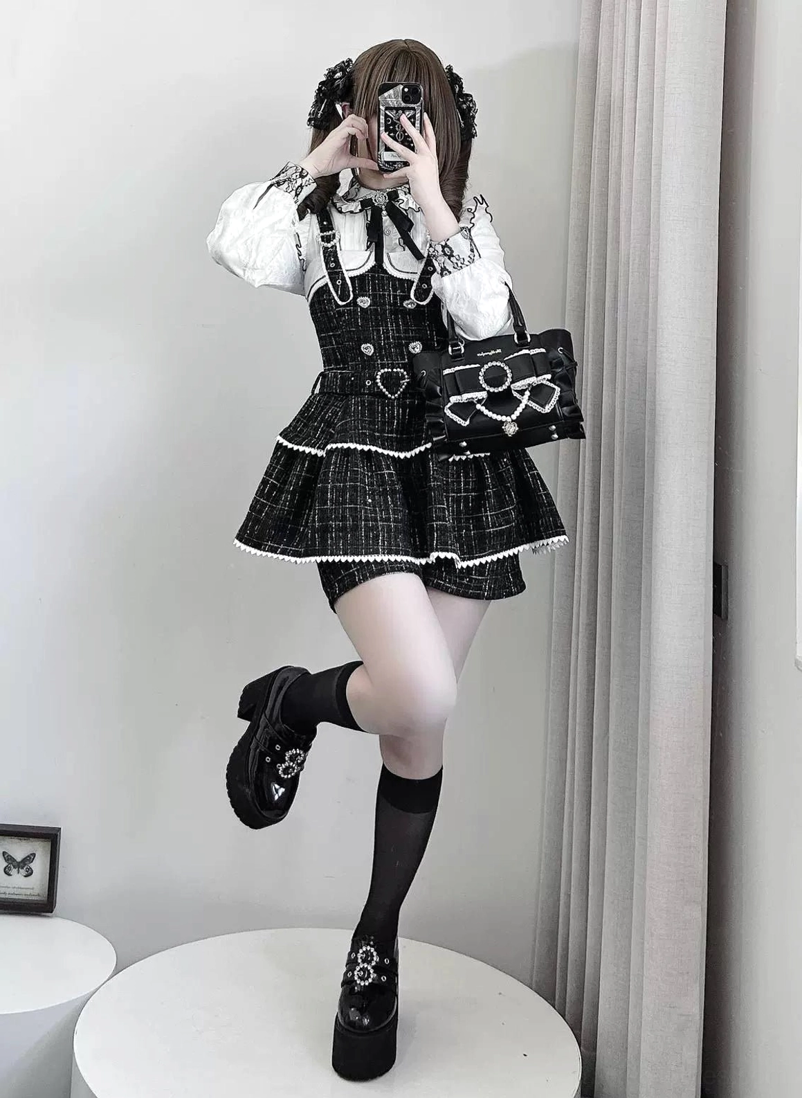 Black plaid Jirai Kei suspender skirt full-body pose showing ruffled hem, matching shorts, studio aesthetic styling