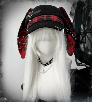 black plaid punk bunny ear beret with red tartan band and safety pins jirai kei gothic hat front three-quarter view