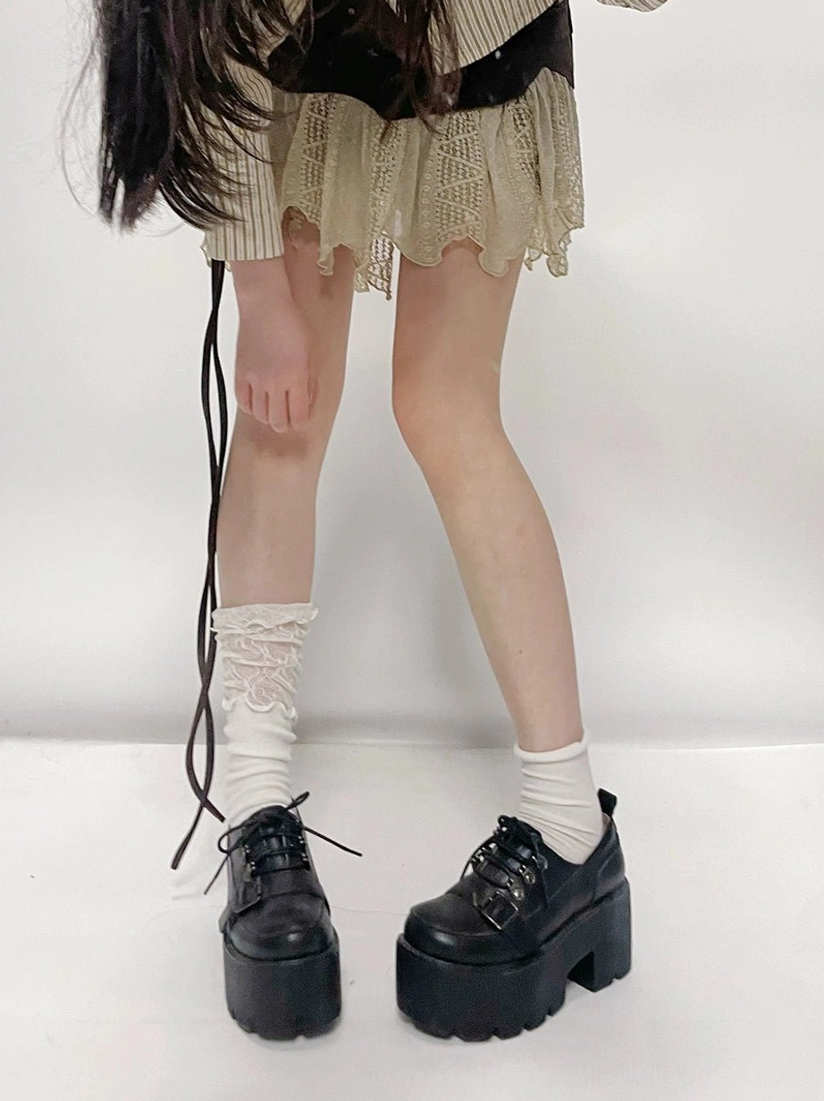 Jirai Kei aesthetic black platform shoes front angle worn with white lace socks and model in frilly outfit creating contrast