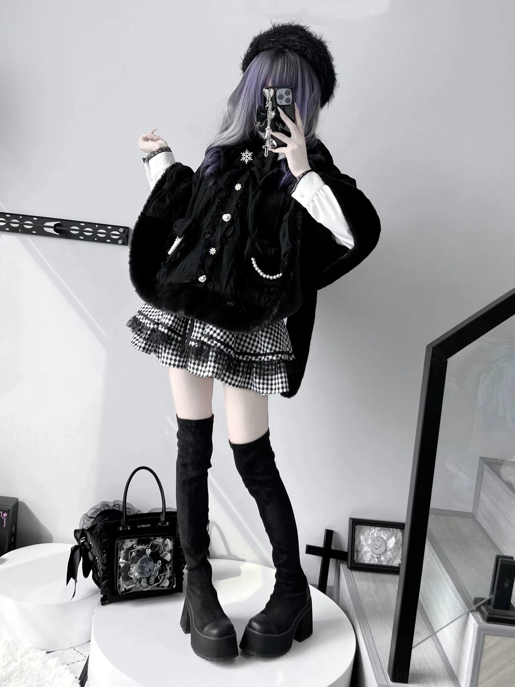 Rear three-quarter mirror selfie of black loose rabbit ear cape silhouette with plaid mini skirt and thigh-high platform boots