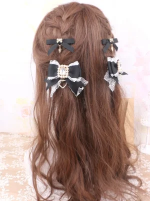 Black rhinestone bow hair clips back view on mannequin with braided brown hair large central bow with rhinestone trim and small side clips jirai kei accessories