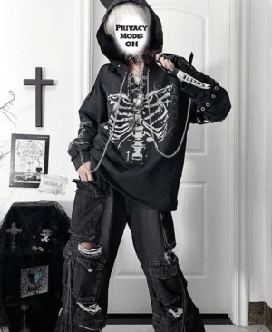 Black tone oversized ribcage print Jirai Kei hoodie with lace-up neckline and chain ornaments, side profile view of hooded model wearing distressed cargo pants and chain accessories in gothic interior setting