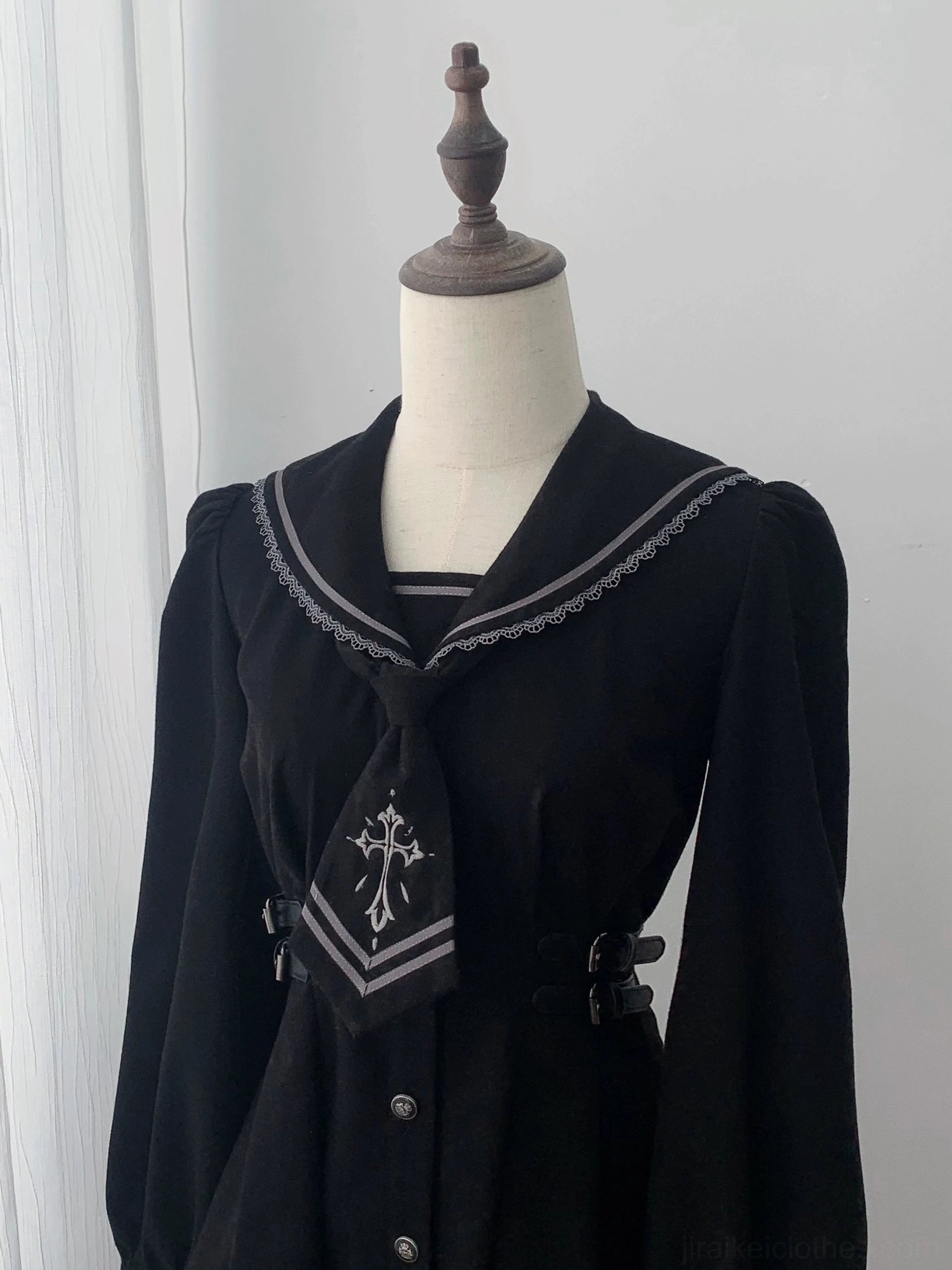 Close-up mannequin display of black sailor collar JK uniform top with lace sailor collar and detachable cross-embroidered necktie design