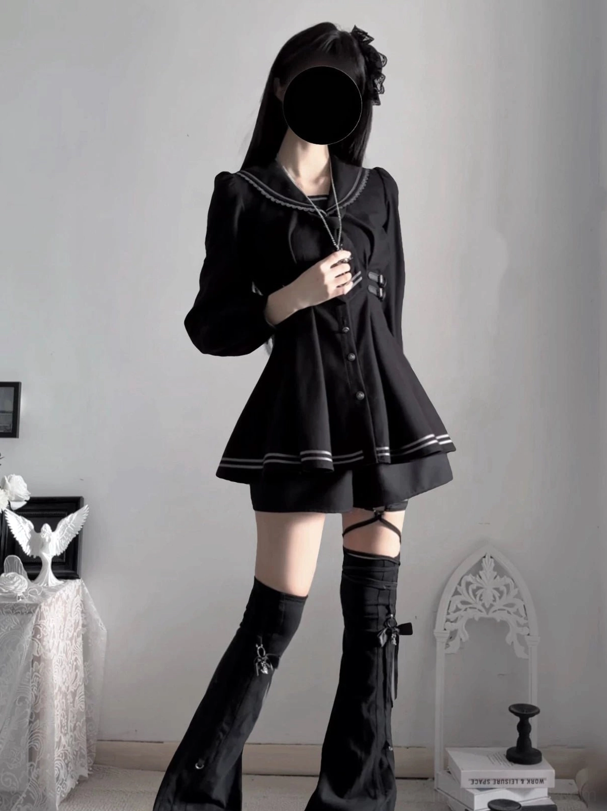 Front view of black sailor collar JK uniform featuring cross-embroidered necktie, fitted waist, and flared pleated skirt with stripe detailing