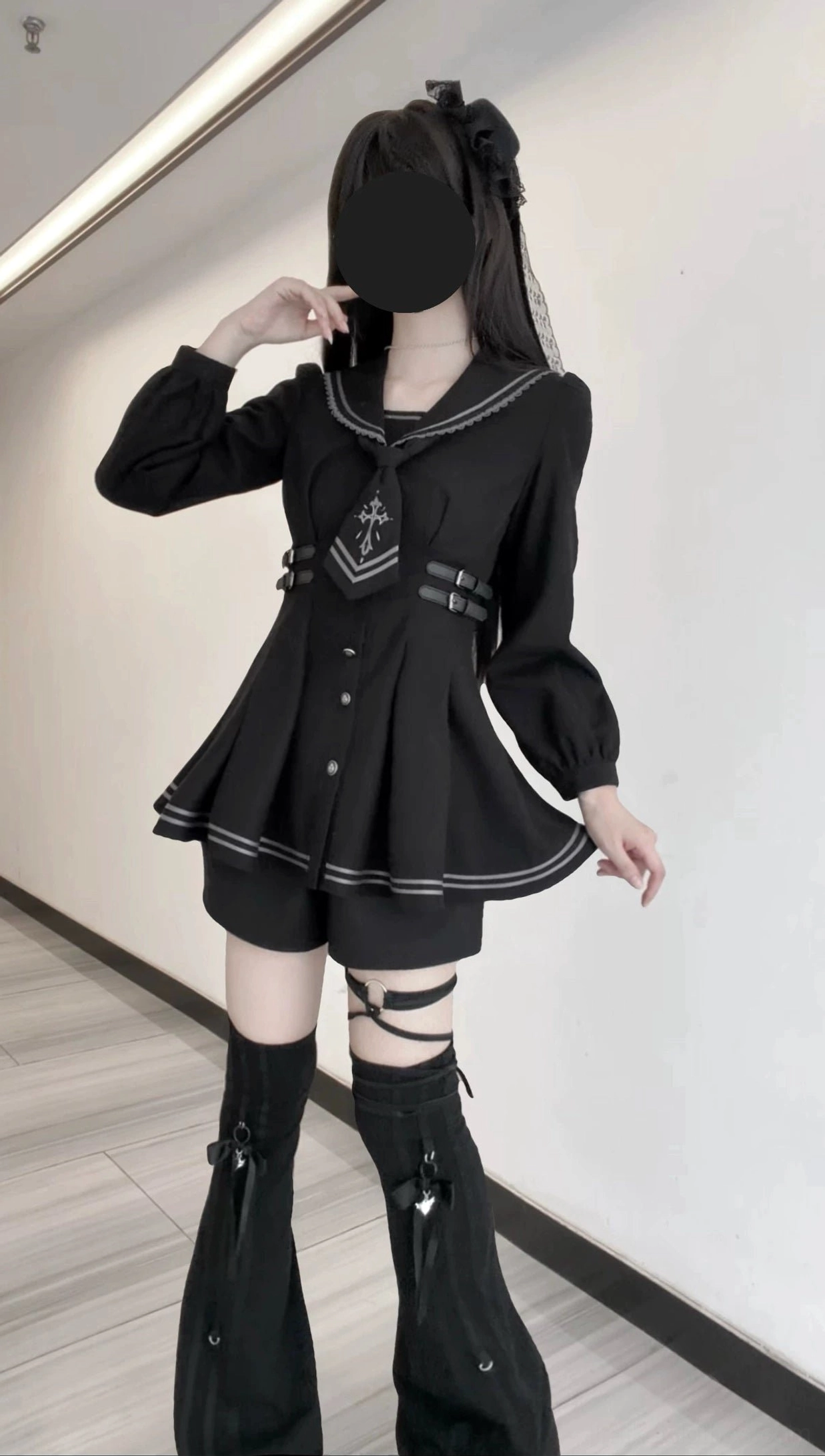 Full body front view of black sailor collar JK uniform dress with single-breasted front, skirt stripe trim, and detachable cross necktie