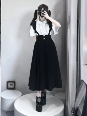 Solid black high-waisted pleated suspender skirt front view seiso kei style indoor fitting room