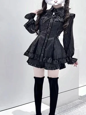 Black striped Jirai Kei two-piece outfit set full-body view on masked model with thigh-high socks, tailored waistline, ruffled hem shorts, and bishop sleeves against studio background