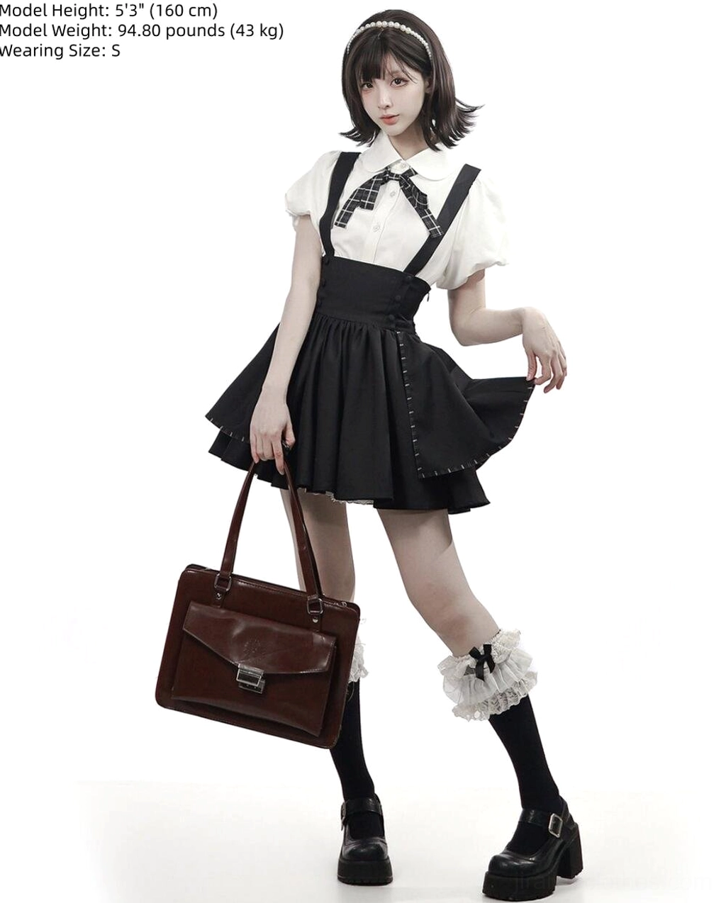 Black jirai kei lolita two-piece set full-body side view showing white bubble sleeve blouse black suspender skirt with leather tote bag