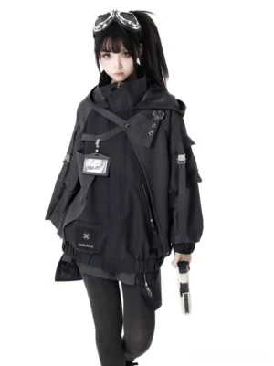 Single female model in black cropped techwear tactical jacket with high stand collar, crossbody strap, and ID patch utility design front view complete look