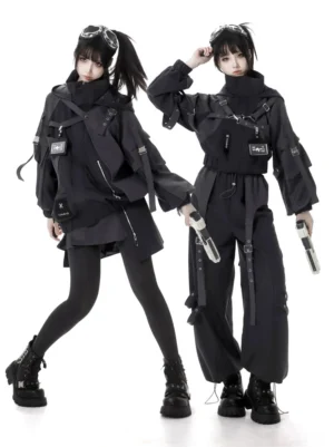 Two female models wearing coordinated black techwear tactical jackets with cargo pants and harnesses, front view studio shot showcasing jirai kei fashion aesthetic with tactical utility details