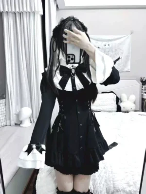 Black and white Jirai Kei dress with heart-shaped buttons, detachable bow collar, lace-up corset waist detailing, and ruffled shorts with pockets - front mirror selfie view showcasing complete outfit aesthetic