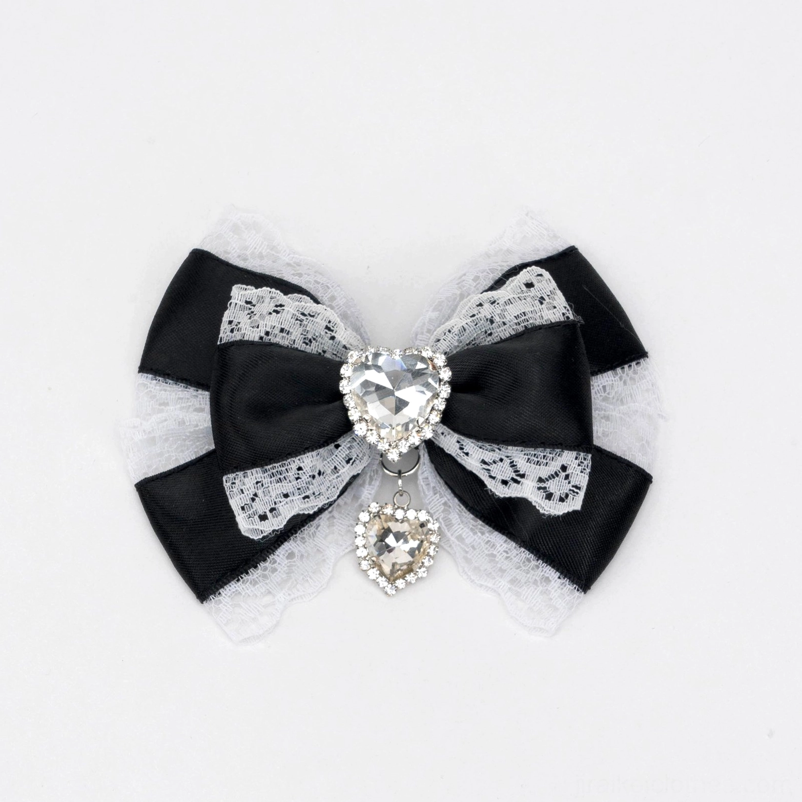 black and white jirai kei lace trimmed bow hair clip close-up with heart rhinestone center and dangling pendant