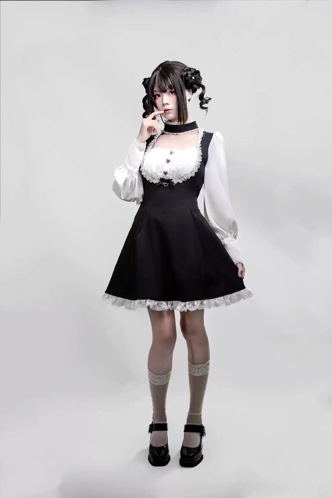 Full frontal display of solid black-white Jirai Kei maid dress with integrated non-detachable choker, showing square neckline, puffed sleeves, lace details and spandex blend fabric