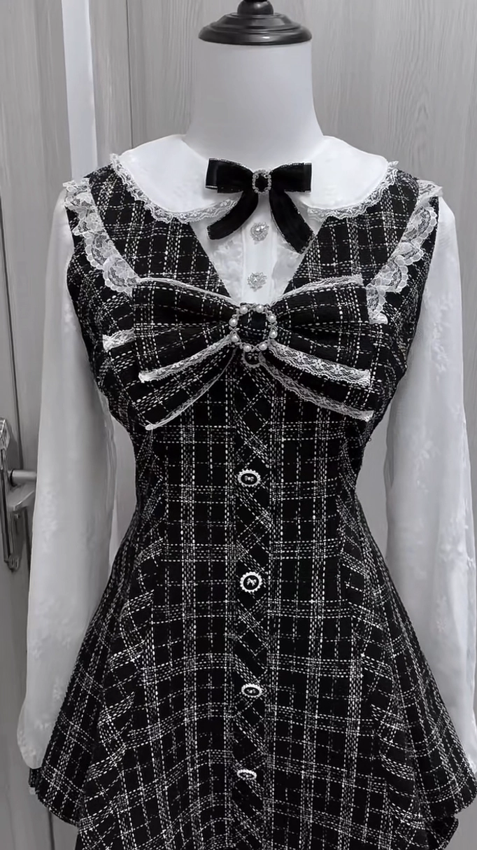 Complete Jirai Kei two-piece set with large rhinestone-embellished front bow on plaid dress, lace Peter Pan collar trim, chiffon sleeves, and matching ruffle-hem shorts