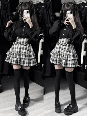 Black-white plaid tiered ruffle Jirai Kei mini skirt with lace trim, worn with black blouse and thigh-high stockings, full-body front view mirror selfie