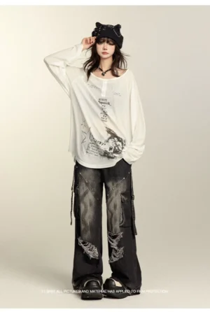 Black wide-leg ripped cargo jeans styled with graphic long-sleeve tee and cat ear beanie, full-body front view demonstrating Jirai Kei street style aesthetic with side cargo straps