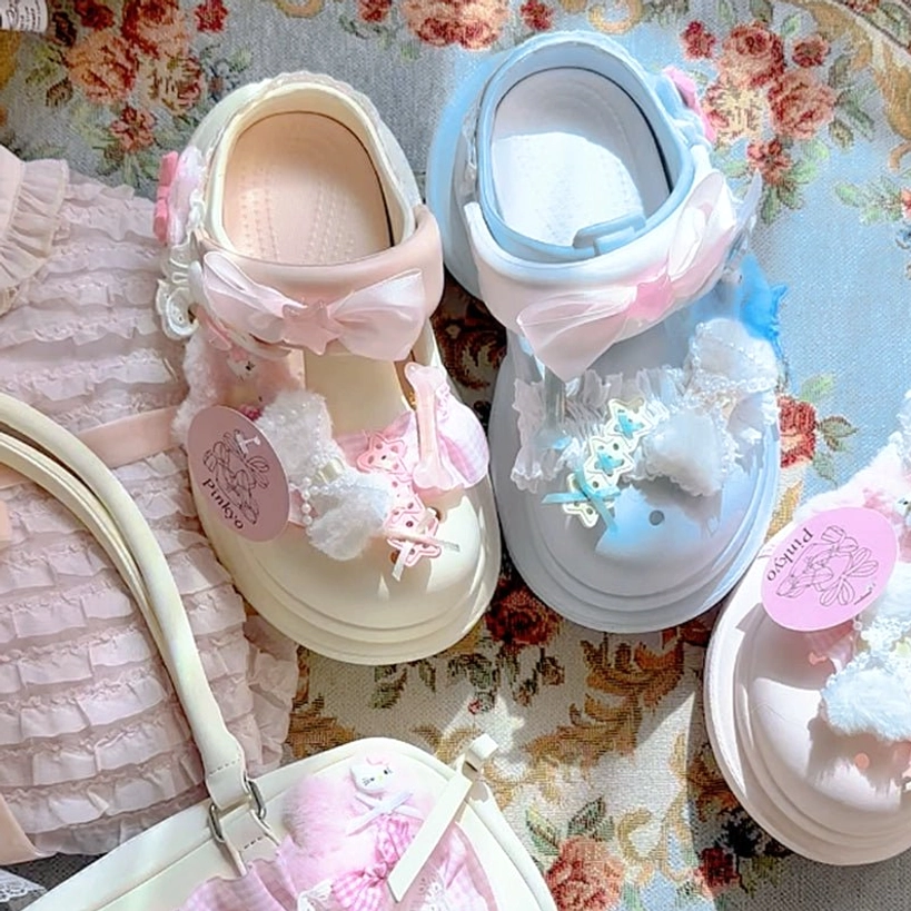 Blue and beige mix-and-match Jirai Kei kawaii clog sandals featuring fuzzy pom-pom trim, lace decoration, bow details, and dual-color platform design